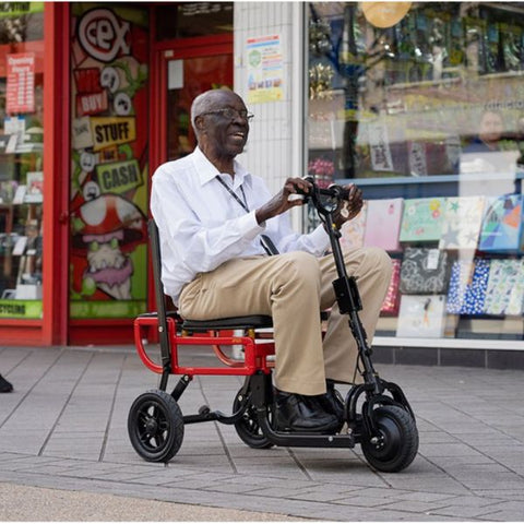 Man riding the eFoldi Lite Lightweight Mobility Scooter Outdoors