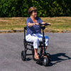Image of Lady riding the eFoldi Lite Lightweight Mobility Scooter Outdoors