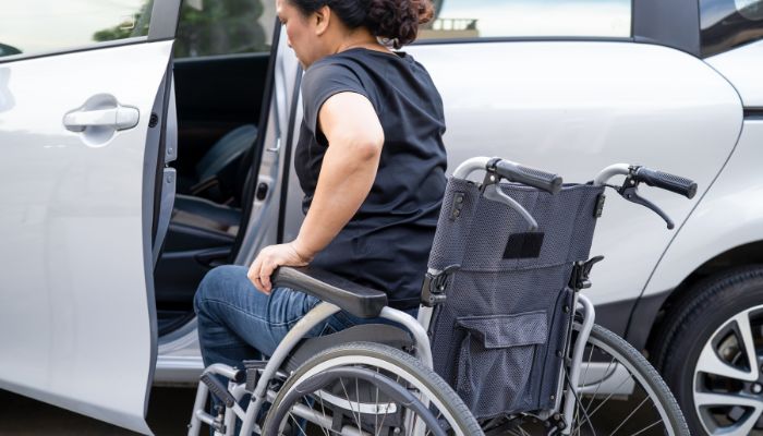 How do you lift an electric wheelchair into a car?