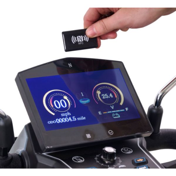 Hand holding a small device above a Golden Technologies Eagle All-Terrain 4-Wheel Mobility Scooter digital display.