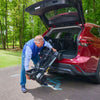Image of A man putting the Buzaaround CarryOn HD scooter in the Trunk