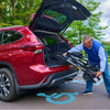 Image of A man placing the Buzzaround CarryOn HD Inside his Car Trunk