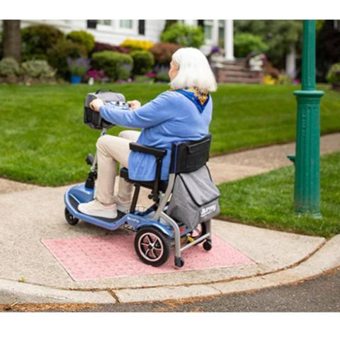 Lady riding the Journey So Lite™ Lightweight Folding Scooter Rear-Left View