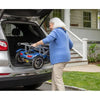 Image of Lady storing away the folded up Journey So Lite™ Lightweight Folding Scooter in the back trunk of a car