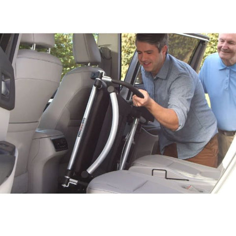 Man easily storing away the Journey Zoomer Chair in the back seat area of a car