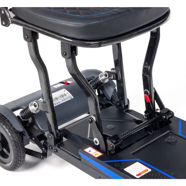 Close-up of Supa Carbon Lite Ultra Lightweight Folding Mobility showing the seat frame, rear suspension springs, motor housing, and deck with blue accent lines on a white background.