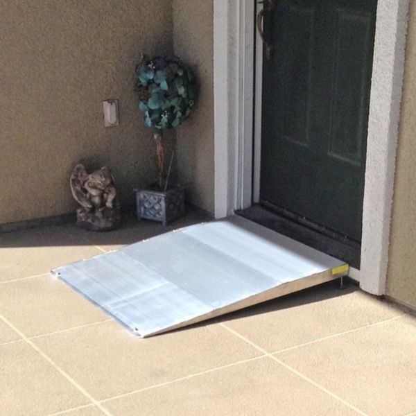 PVI Adjustable Threshold Ramp leading up to a door on a tiled patio
