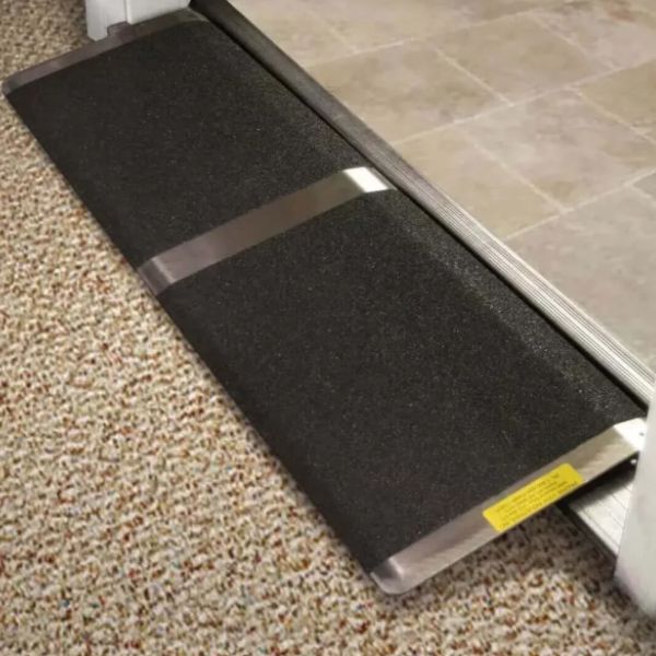 PVI Aluminum Solid Bariatric Threshold Ramp on a carpeted floor with a tiled surface in the background