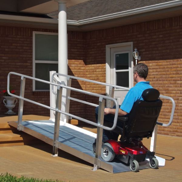 Person using a power wheelchair with PVI OnTrac Wheelchair Ramp with Handrails  in front of a house