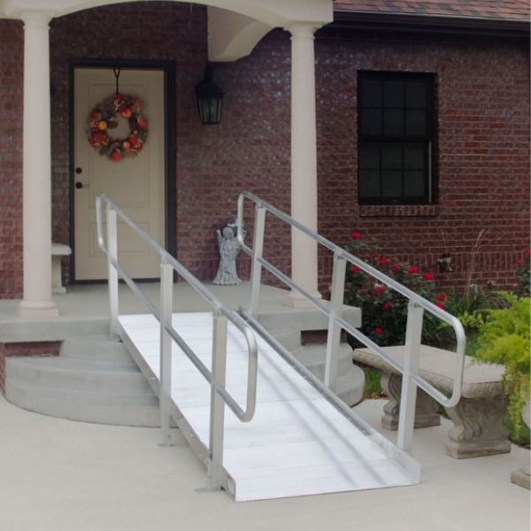 PVI OnTrac Wheelchair Ramp with Handrails  leading up to a brick building with a wreath on the door