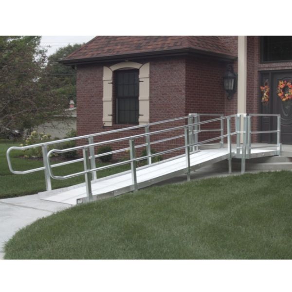 PVI XP Modular Wheelchair Ramp with Handrails leading to a brick building with a wreath on the door.