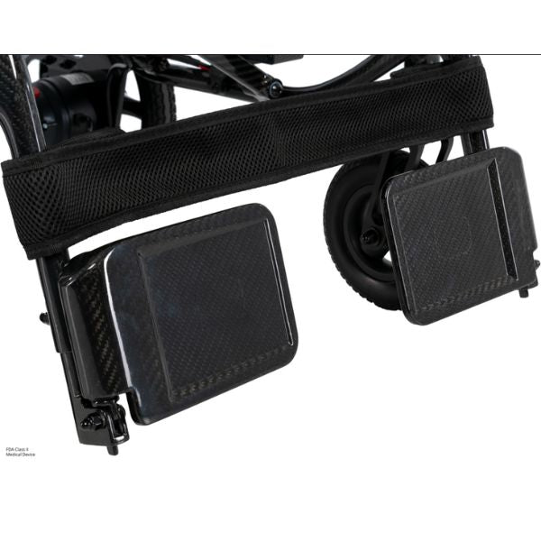 Close-up of a Pride Jazzy Carbon 27X Lightweight Folding Wheelchair footrest mechanism on a white background