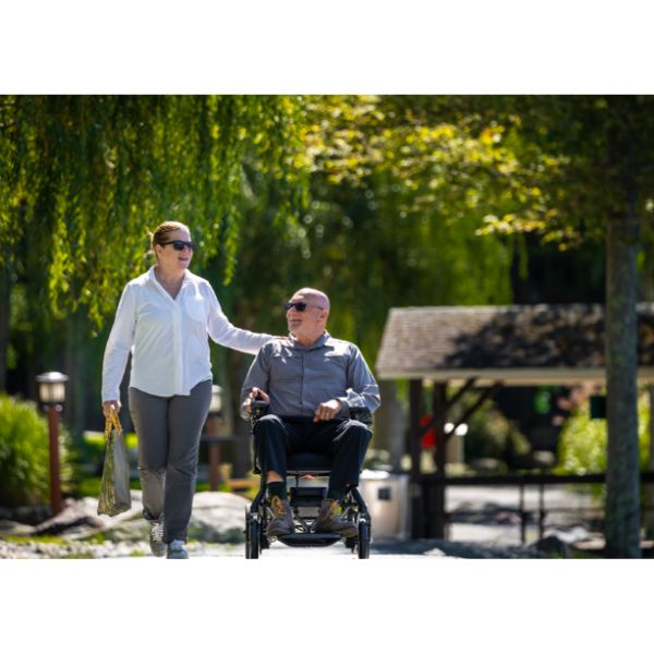 Pride Jazzy Ultra Light Portable Power Chair  Front View with Rider