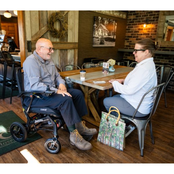 Pride Jazzy Ultra Light Portable Power Chair  Side View with Rider