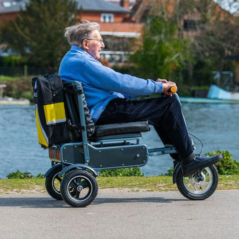 Man riding the eFOLDi Explorer Ultra Lightweight Mobility Scooter Right side view