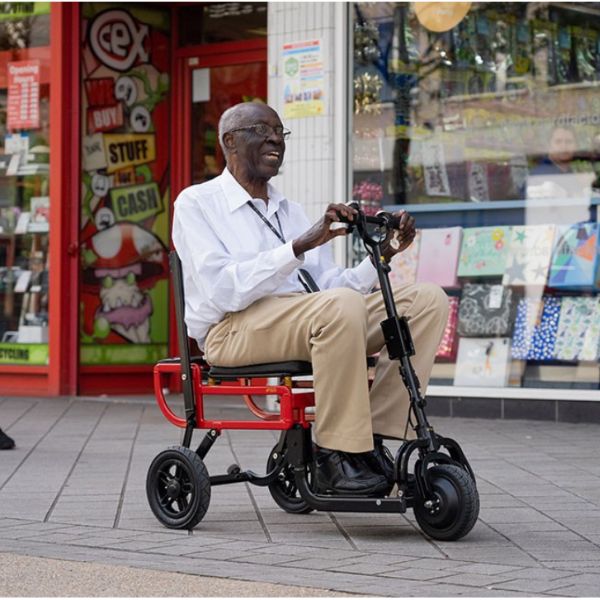 A lightweight mobility scooter, the eFoldi Lite, is showcased in this image. It features a sleek design with foldable capabilities, making it convenient for transportation and storage. The scooter is electric-powered and offers enhanced mobility for individuals with limited mobility.