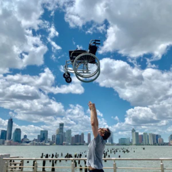 Man throwing the Feather Lightweight Wheelchair in the air 