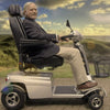 Image of Quingo Toura 2 Heavy Duty Mobility Scooter Side View With Man View